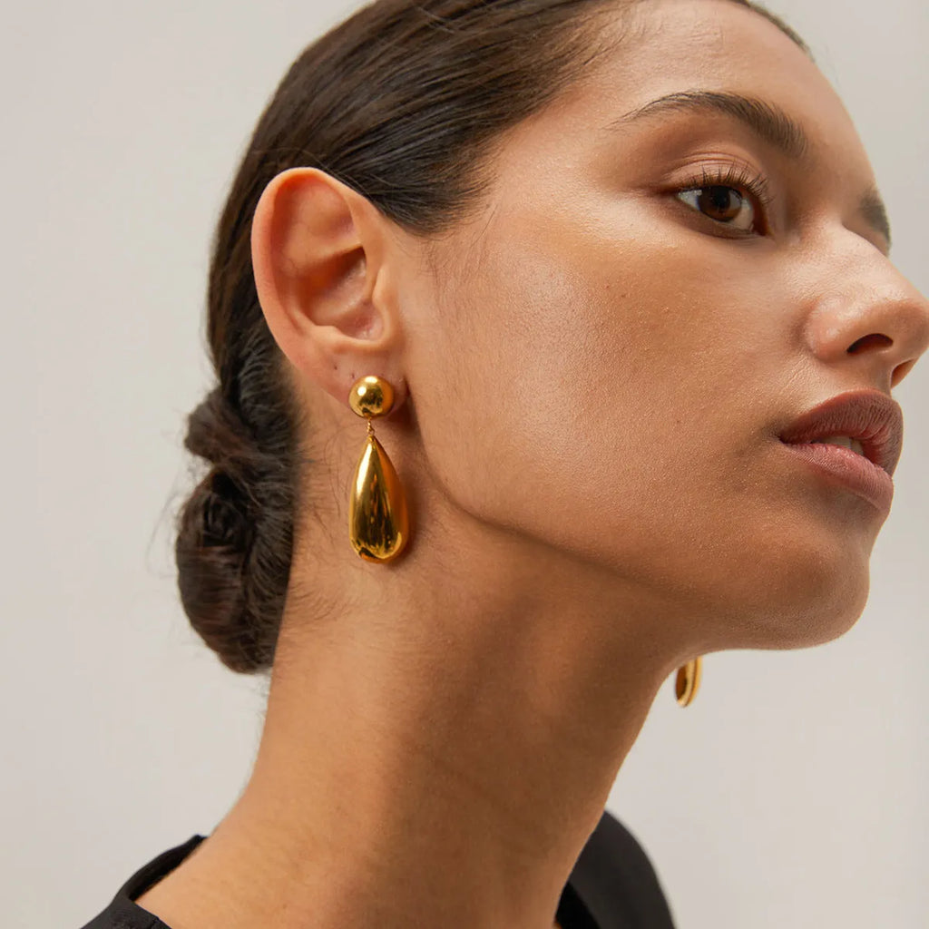Gold electroplated stainless steel earrings with geometric water droplet hemisphere pendant design