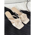Beige women's sandals with a chunky heel, square toe, and a single satin strap across the foot.