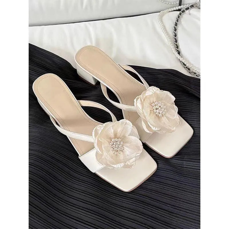 Beige women's sandals with a chunky heel, square toe, and a single satin strap across the foot.