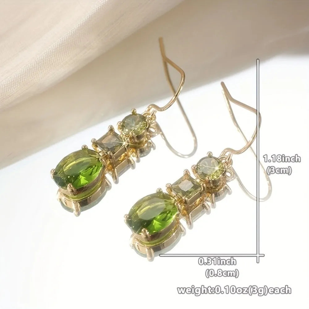 A pair of green geometric quadrilateral earrings made from copper, showing a simple retro bohemian style.
