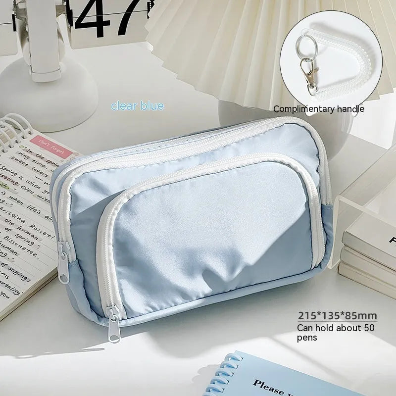 Double layer high capacity pencil case in blue with gift handle, showing zippered compartments.