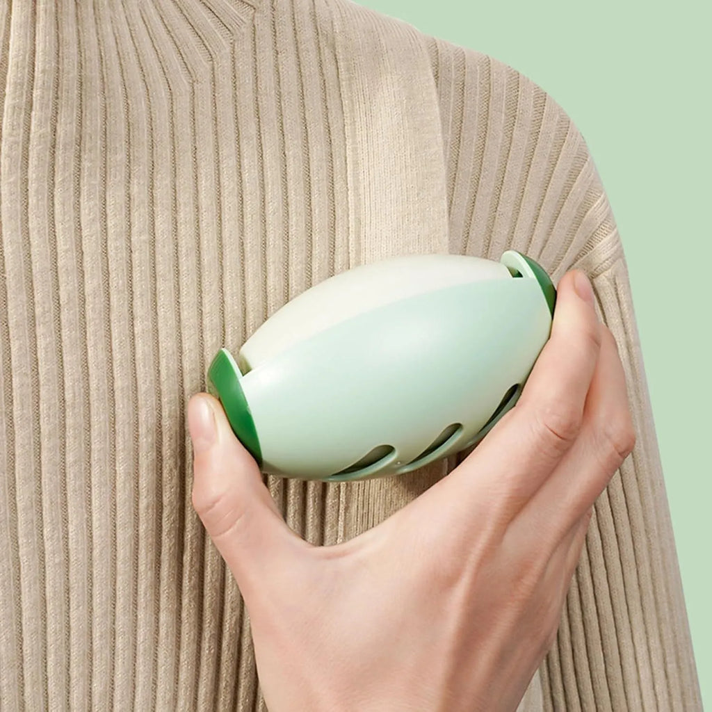 Green and white reusable gel lint roller ball for pet hair removal on fabrics