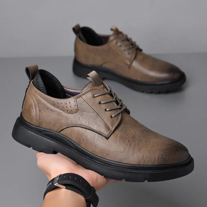 Men's black and brown leather casual sneakers with decorative stitching and a rubber sole.