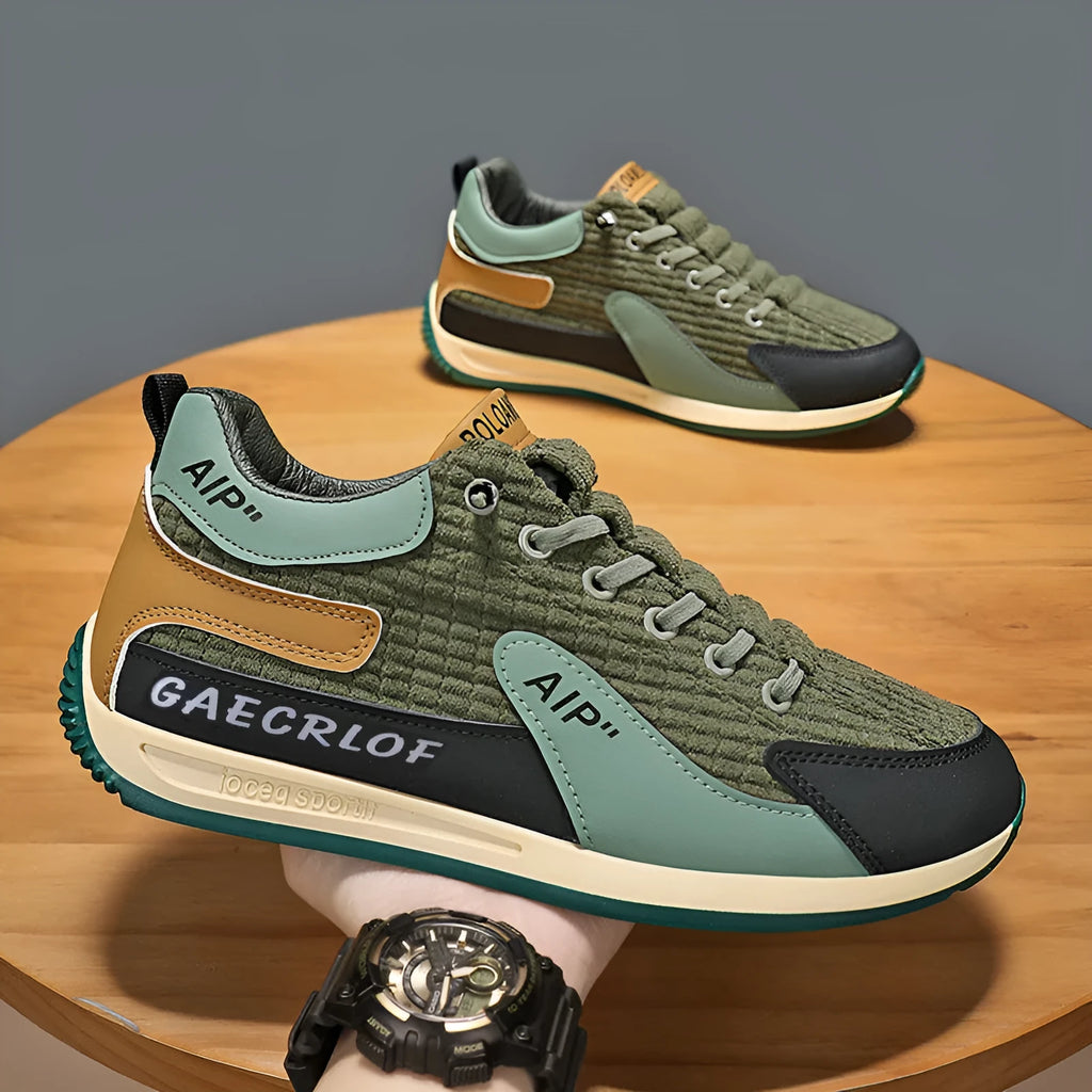 Men's grey and green mesh low-top lace-up running shoes on a white background.