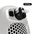 White ceramic electric hot air blower heater with remote control on a table.
