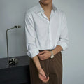 Black men's long sleeve cardigan shirt in slim Korean cut with Japanese retro style details on a model.