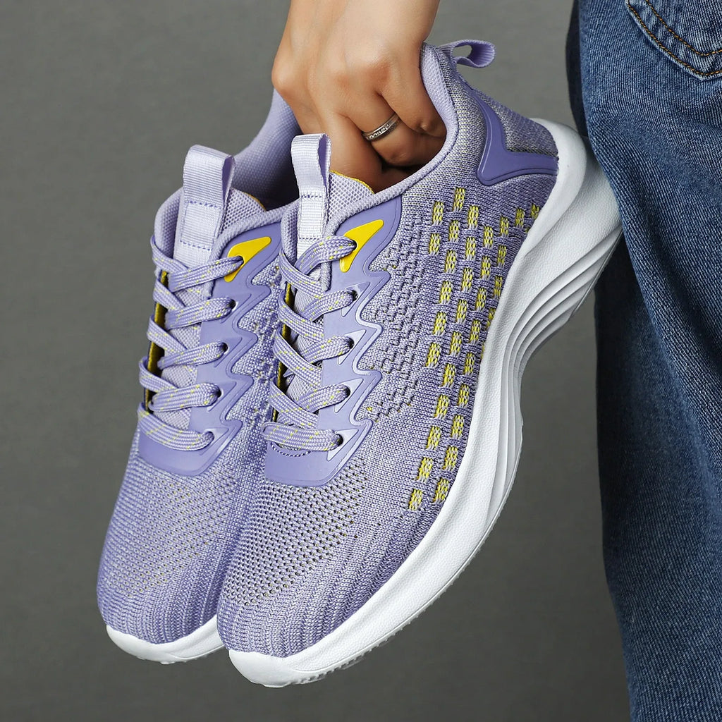 Women's lavender purple Flyknit running shoes with mesh lining and EVA sole on a white background.