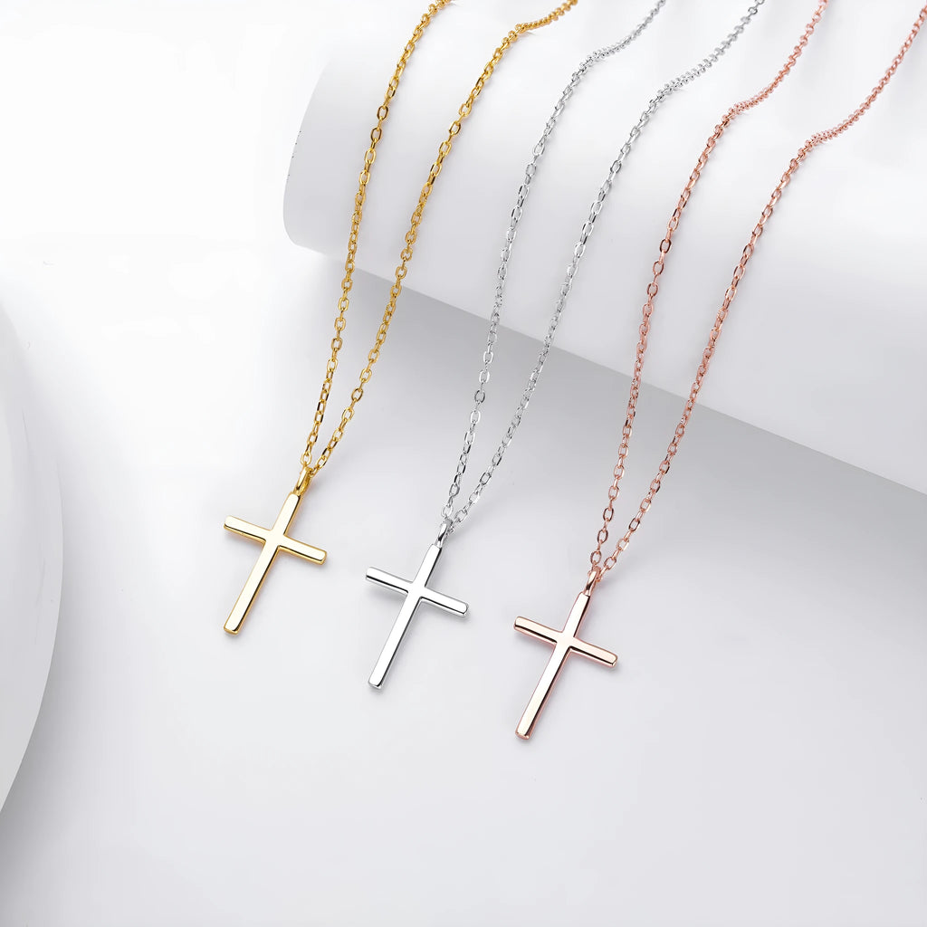 Simple glossy cross pendant on a sterling silver O-chain necklace, shown in gold, platinum, and rose gold finishes.