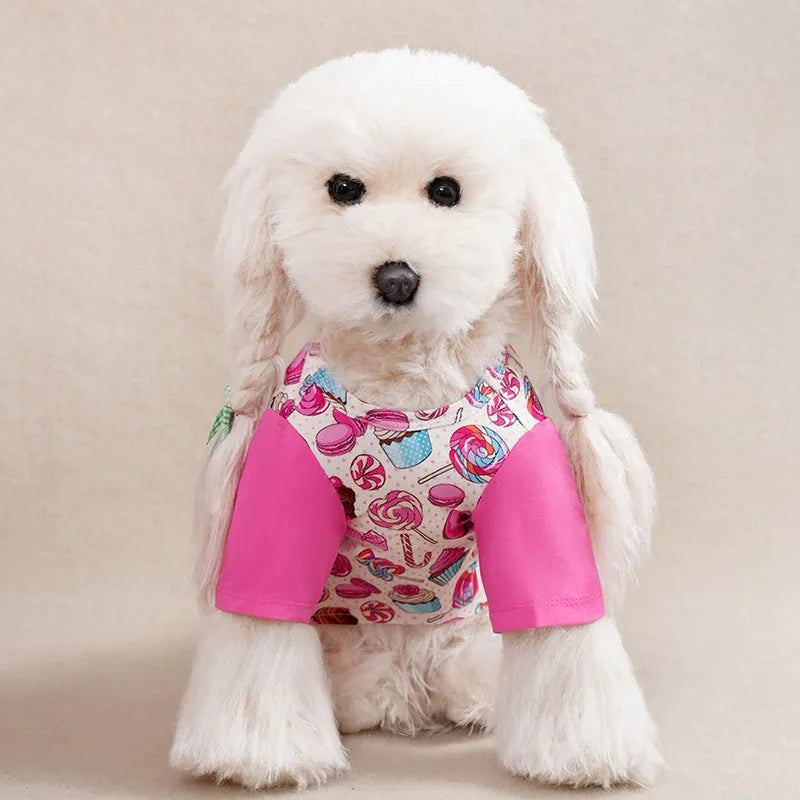 A small dog wearing a casual, printed polyester T-shirt, showing the full design and fit.