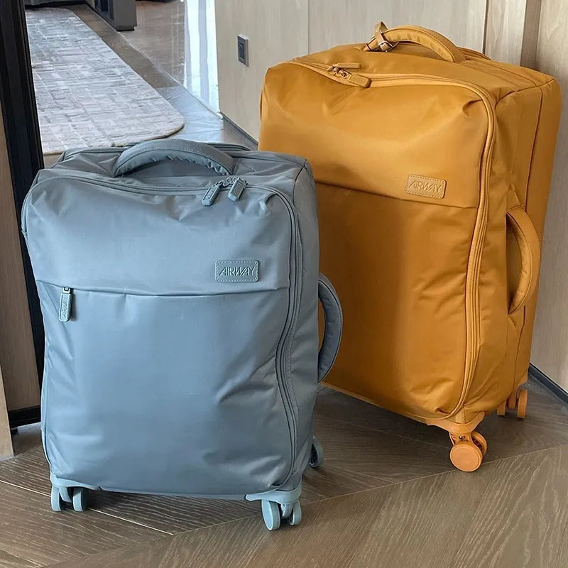 Ultra-light waterproof Oxford cloth suitcase in bluestone green with universal wheels, 20-inch size shown.