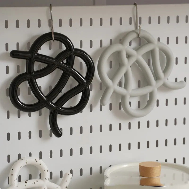 Ceramic heat proof mat in irregular shape protecting dining table from hot pan