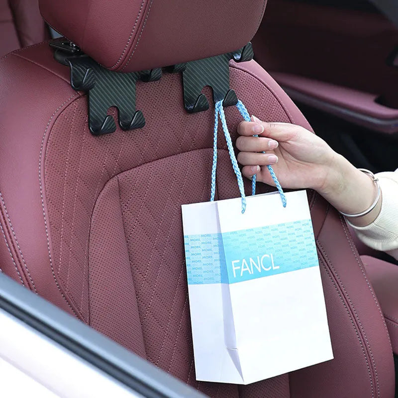 Black ABS plastic car multifunction hook and mobile phone holder bracket for rear seat storage.
