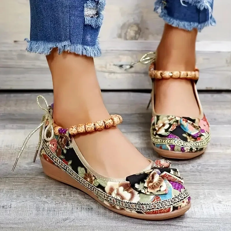 Women's black plus size ethnic platform sandals with elastic band fastening.