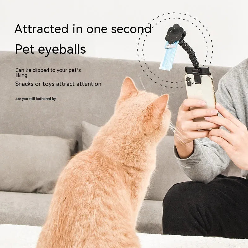 Black pet photography tool with a clip for holding treats and a phone holder on a rotating support