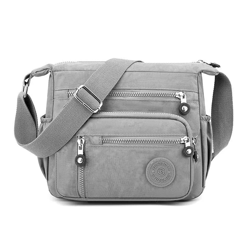 Nylon messenger bag with square vertical shape and single shoulder strap in available colours