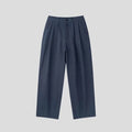 Man wearing apricot wide-leg cotton linen trousers with a mid waist and zip fly.