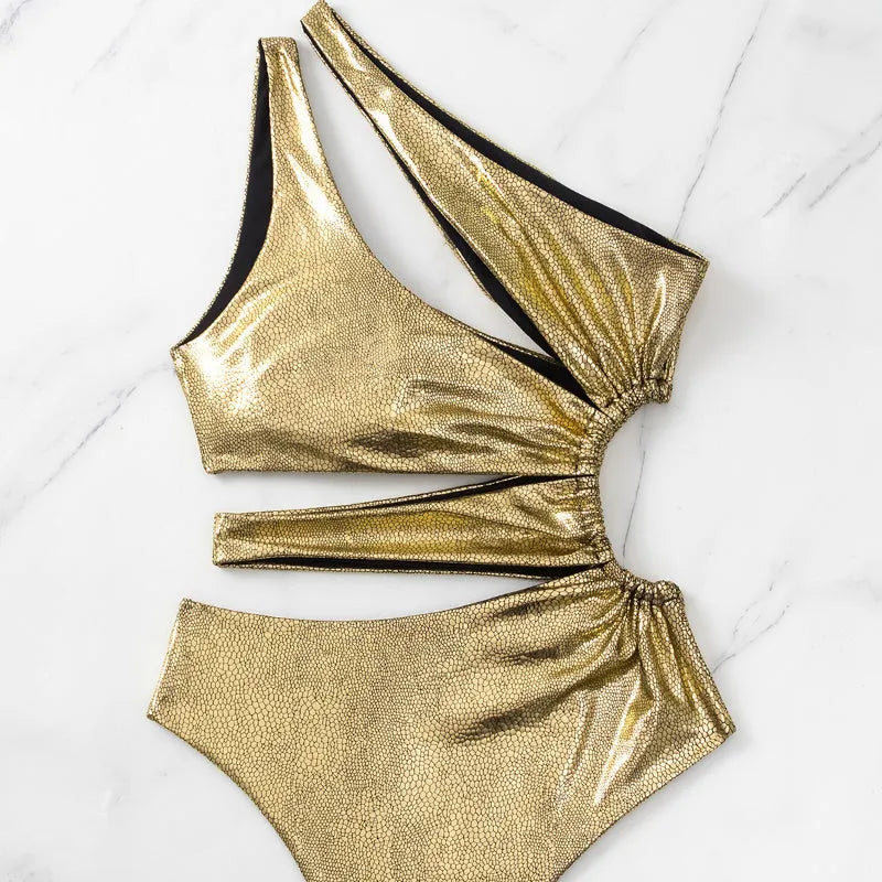Women's one-piece swimsuit in gold with a backless design.