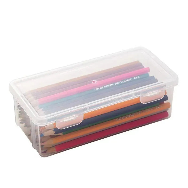 Transparent plastic pencil storage box full of coloured pencils and crayons