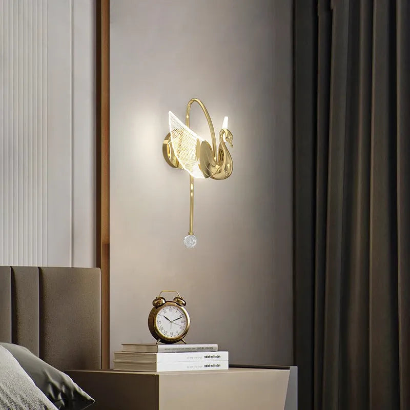 Gold minimalist swan-shaped wall lamp with acrylic shade and dimmable LED light.