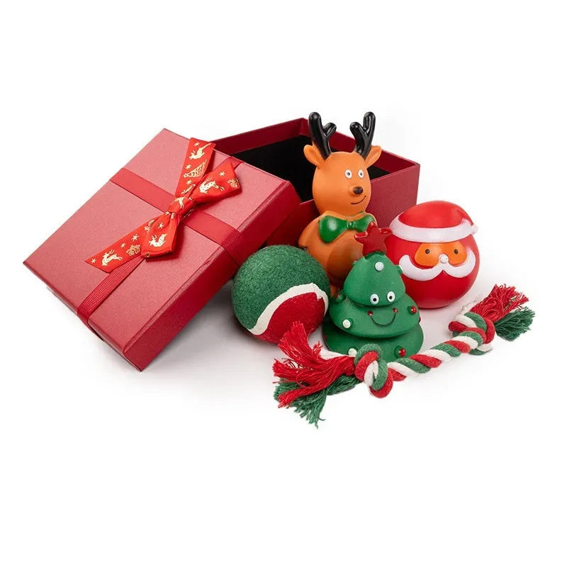 Set of vinyl Christmas-themed dog chew toys including balls, ropes, and Santa shapes in a gift bag.