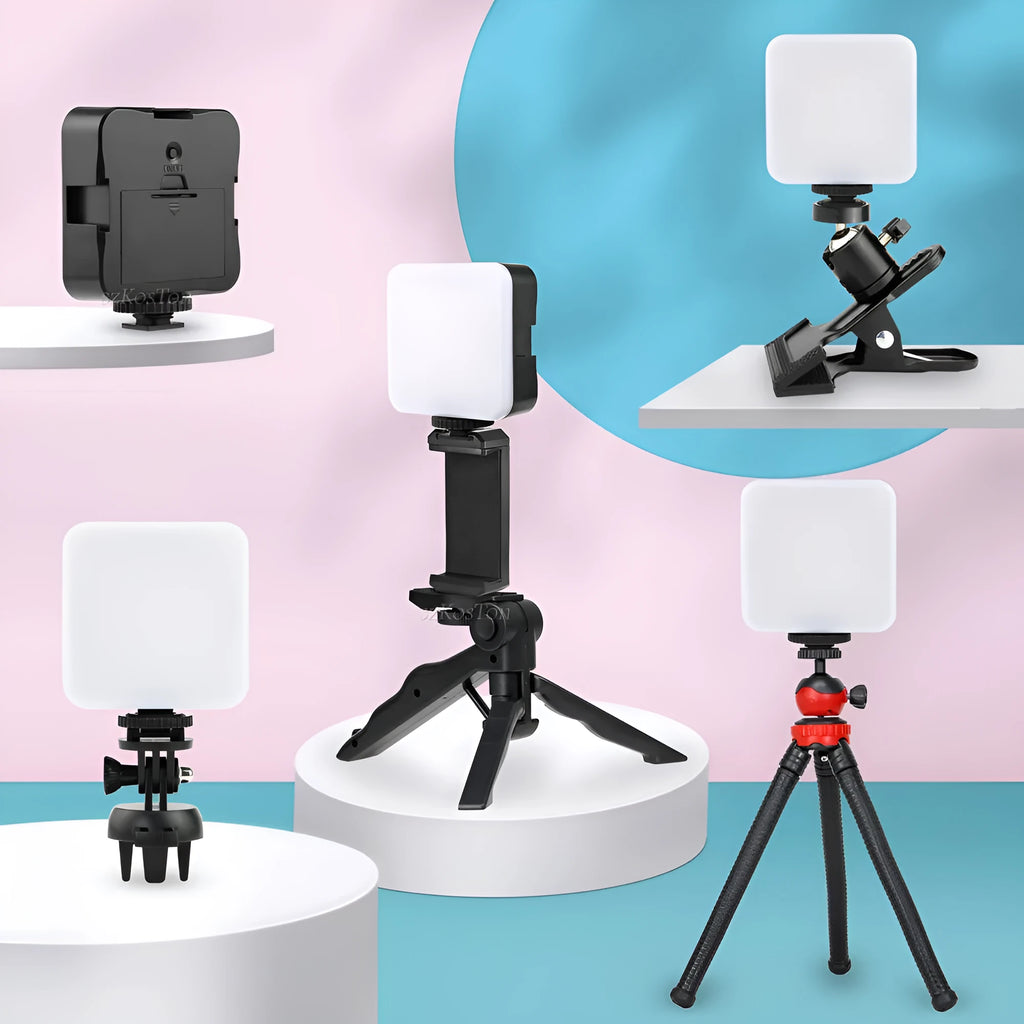 Compact black LED mini square camera flash with hot shoe mount on a small tripod stand.
