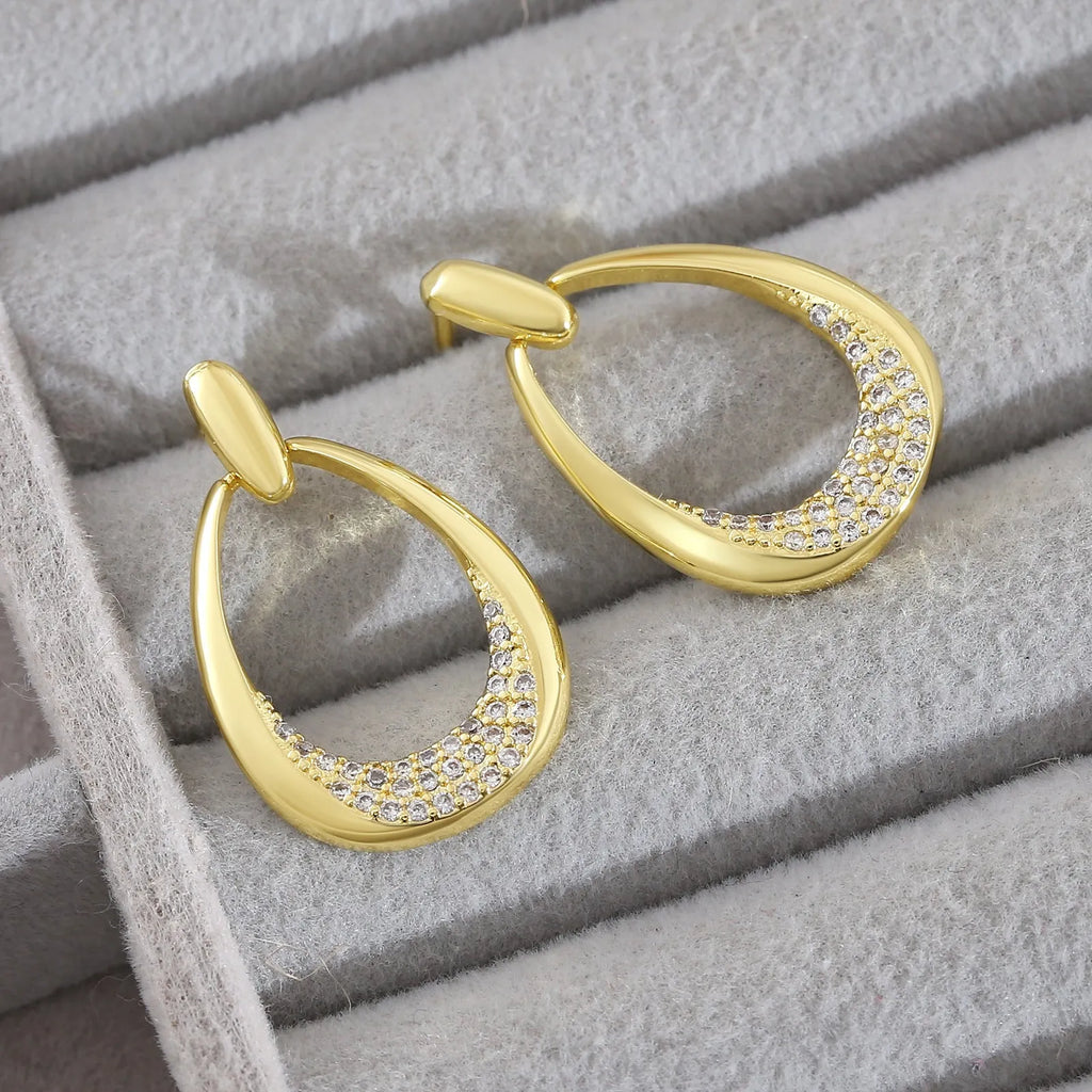 Geometric drop-shaped women's earrings in yellow gold colour with zircon design elements