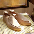 Men's brown genuine leather handmade loafers with a flexible TPR sole on a white background.