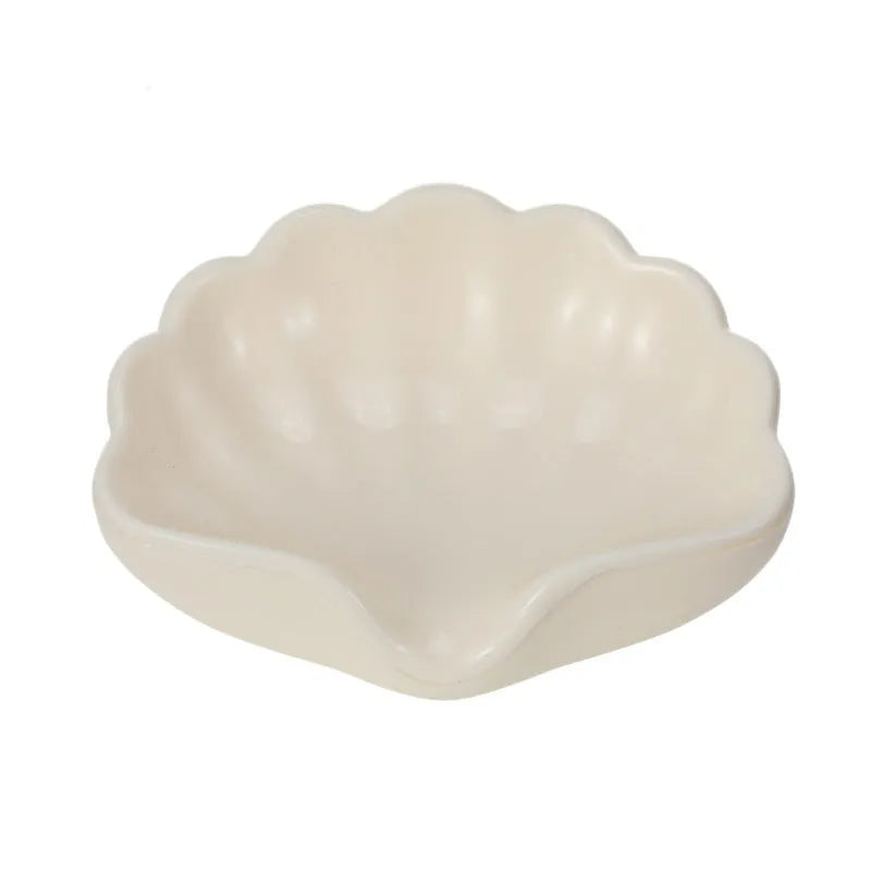 Plastic shell-shaped soap dish in pearl white or cherry blossom pink for bathroom organisation