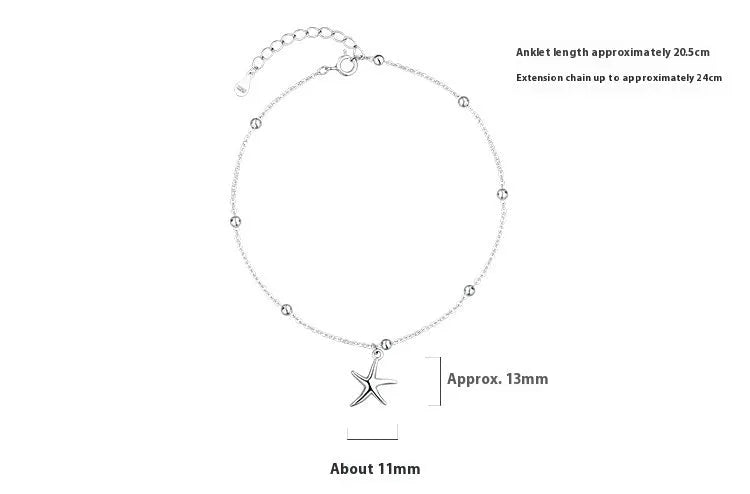 Close-up of a sterling silver anklet with a small starfish charm on a woman's ankle.