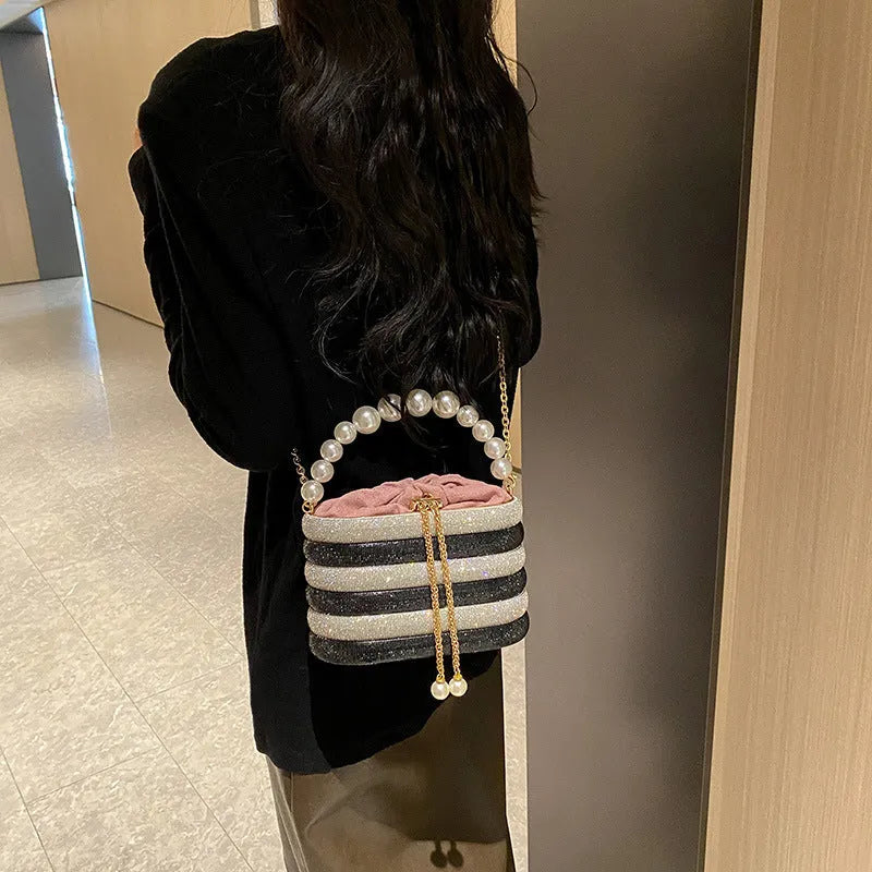 Women's retro style crossbody bag with pearl beading in soft PU, round shape with single strap.