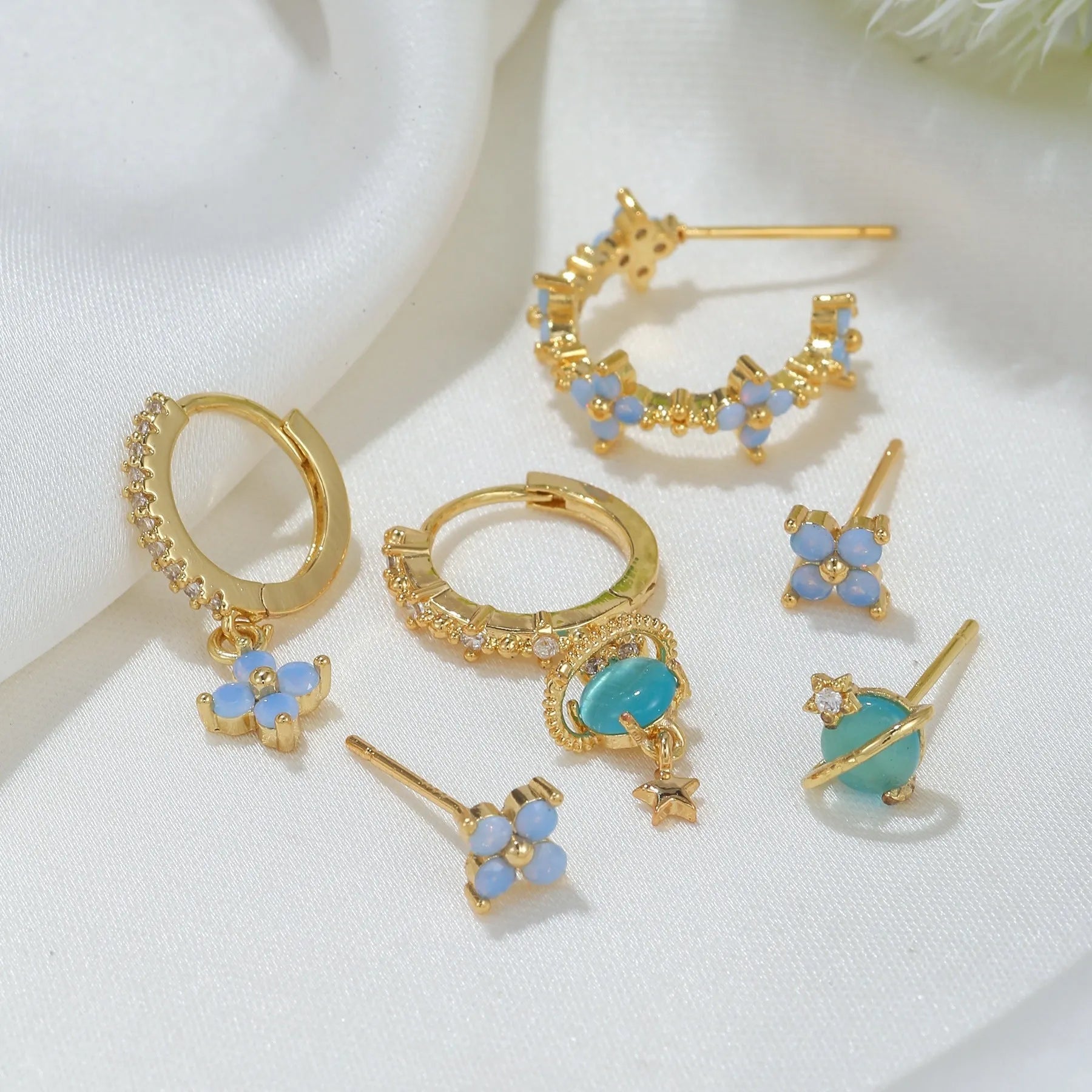 Gold and silver floral ear studs with zircon mosaic stones and geometric metal design