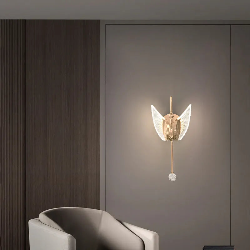 Gold minimalist swan-shaped wall lamp with acrylic shade and dimmable LED light.