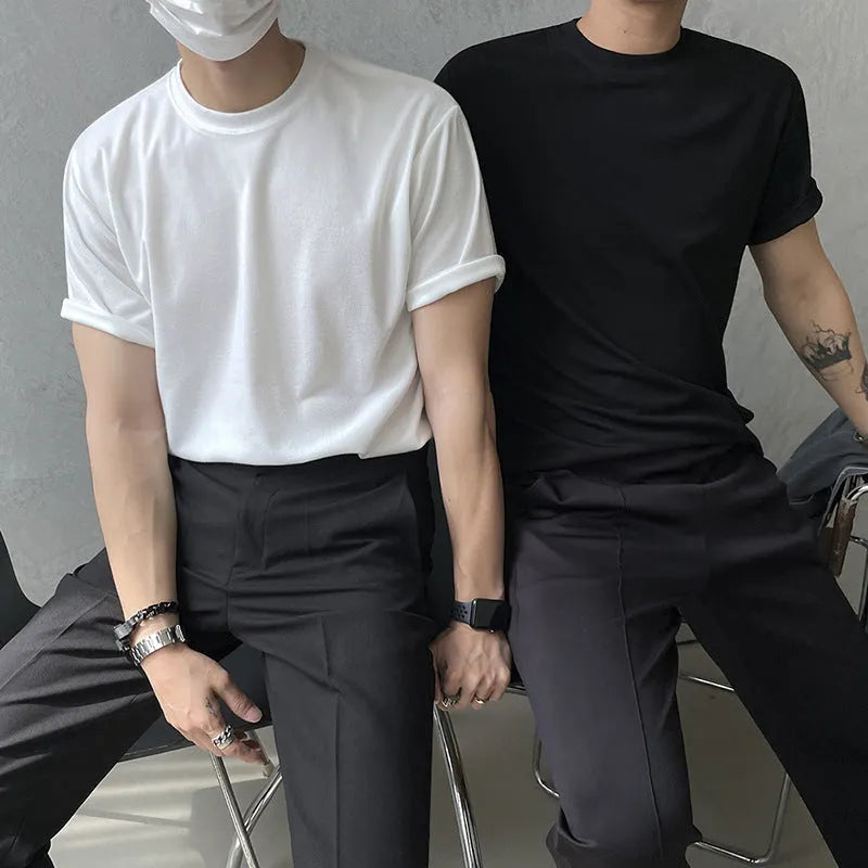 Men's slim fit cotton half sleeve t-shirt in black, showing round neck and regular sleeve design.