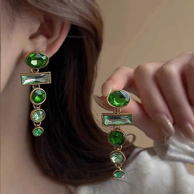 A pair of green gradient geometric alloy earrings with tassels and a zircon stone, shown on a white background.
