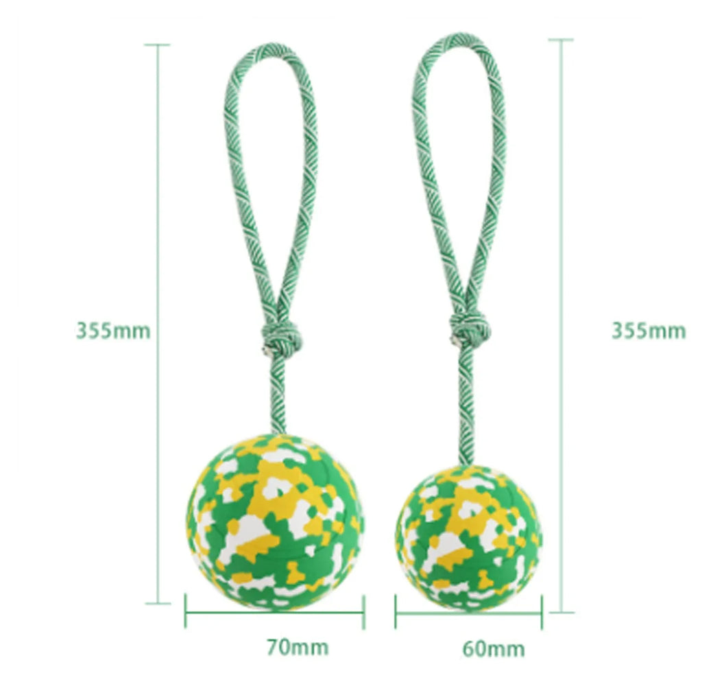 Natural rubber dog ball attached to a nylon rope for interactive fetch and tug-of-war play
