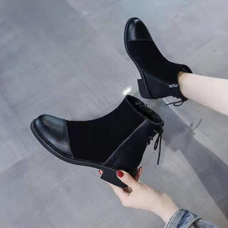 Women's black Martin boots with side zipper, round toe, and knee-length design