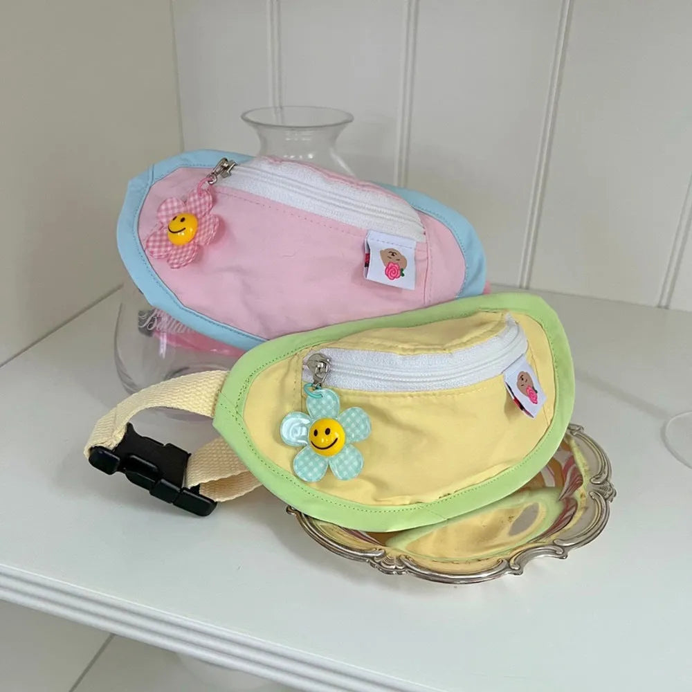 Pink and yellow backpack-style carrier for small dogs or cats, showing mesh panels and a poop bag holder.