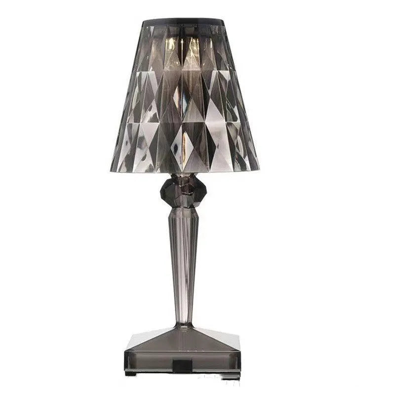 Rose gold portable touch night light with acrylic lamp holder on a surface