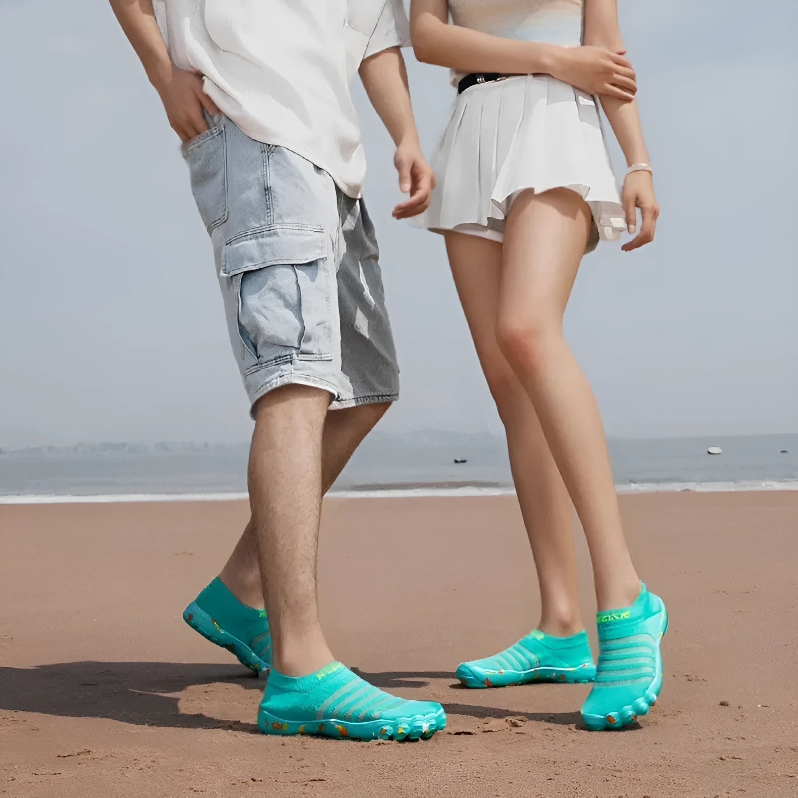 Camouflage pattern water shoes with Flyknit upper and rubber sole, shown on a rocky shore.