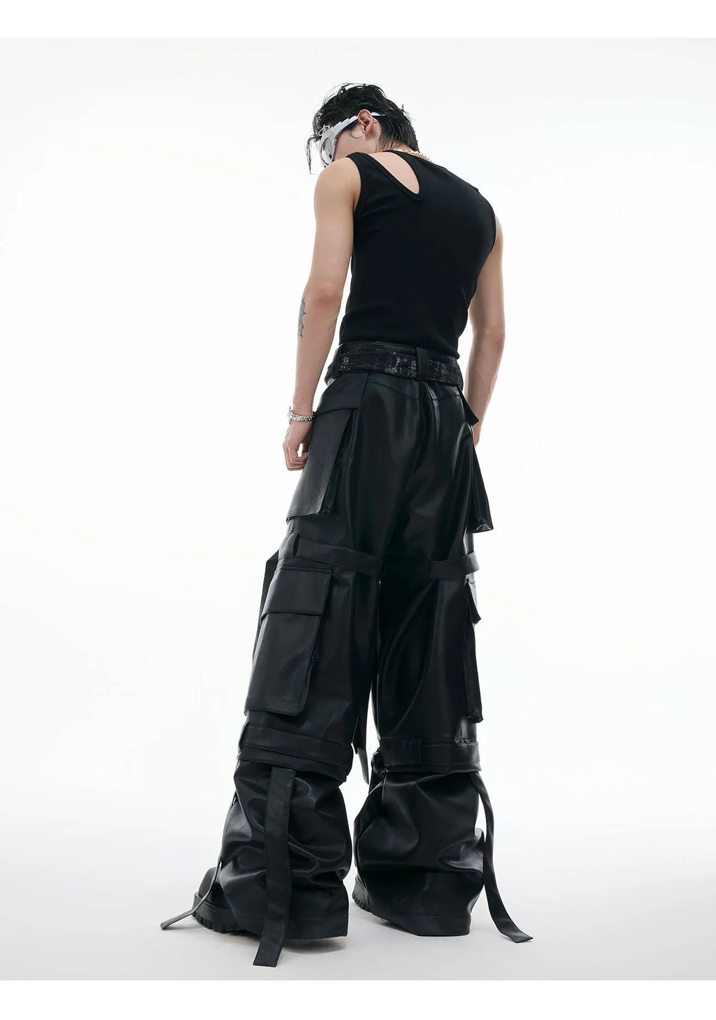 Black loose-fit retro trousers with quilted panels and multi-pocket stitching detail.