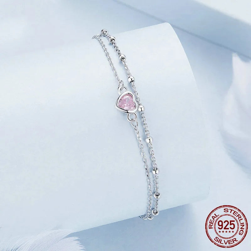 Women's sweet style sterling silver bracelet with a small heart-shaped charm on an adjustable chain.