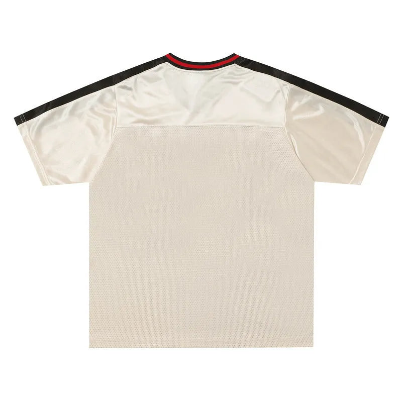 Apricot loose V-neck sports jersey with letter pattern and drop-shoulder sleeves on a hanger.