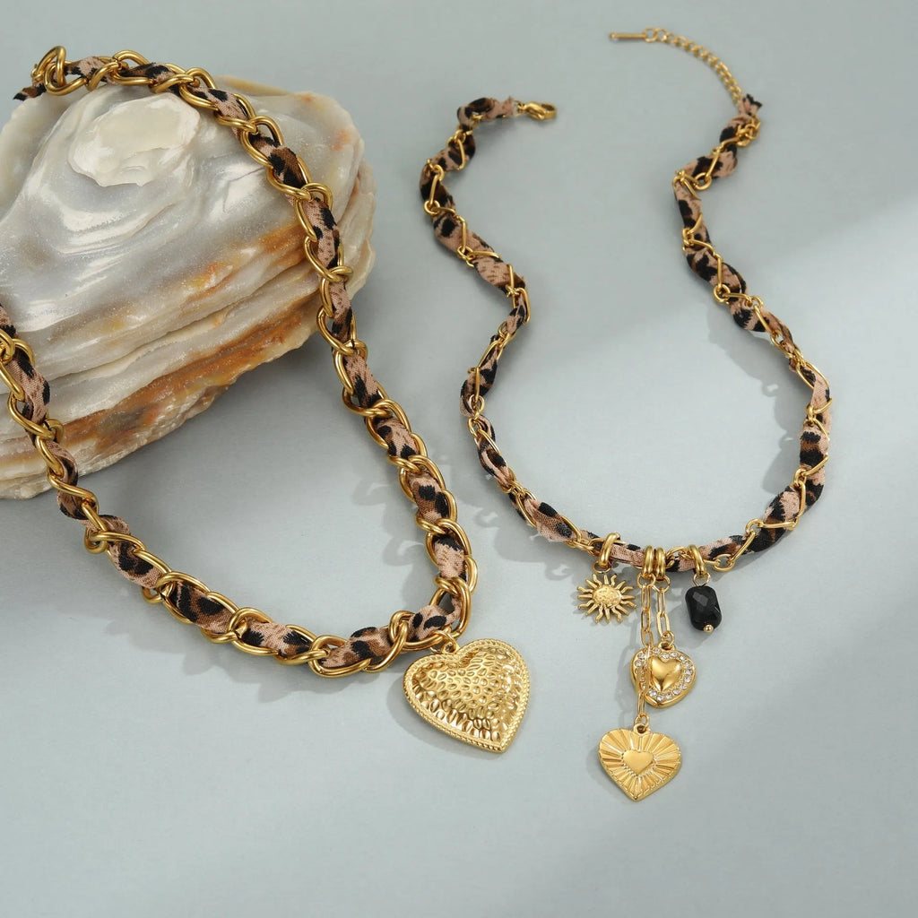 Leopard Love stainless steel necklace with geometric heart or sun pendant on a gold plated adjustable chain.