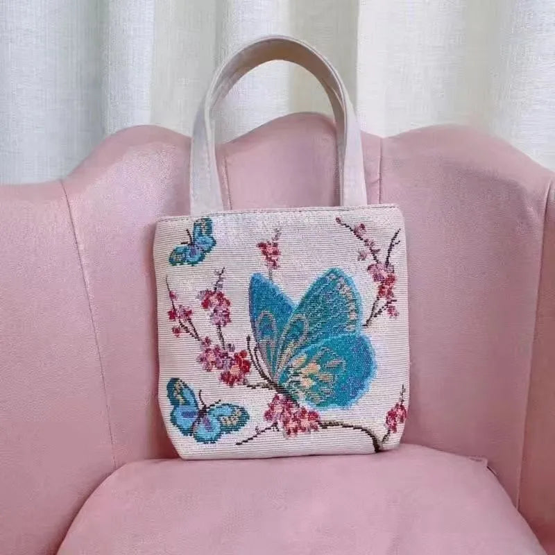 Double-sided embroidered canvas bag with gold wire detailing showing botanical pattern