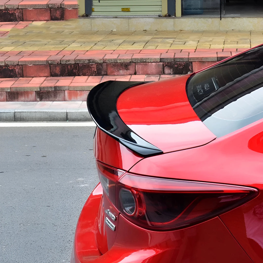 Bright black tail trim for Mazda 3 Exela 2014-2021 models showing large fixed wind-surrounded design