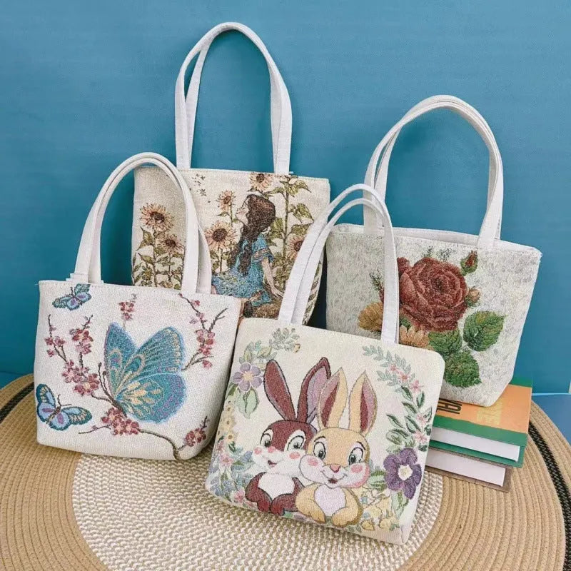 Double-sided embroidered canvas bag with gold wire detailing showing botanical pattern