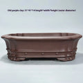 Handmade purple sand rectangular antique flower pot on a desktop.