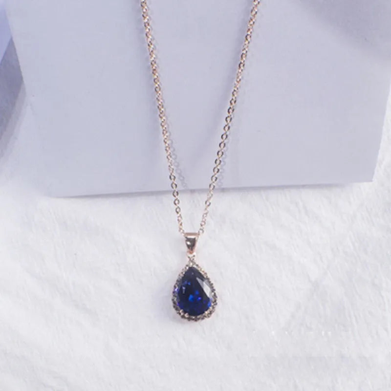 Pink drop shape women's necklace with geometric pendant design and rhinestone details