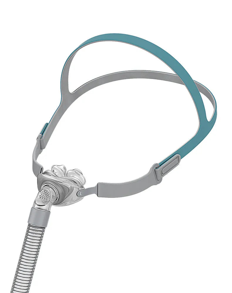 Ventilator nasal pillow mask kit with plastic frame, silicone nose cushion, and adjustable headband.