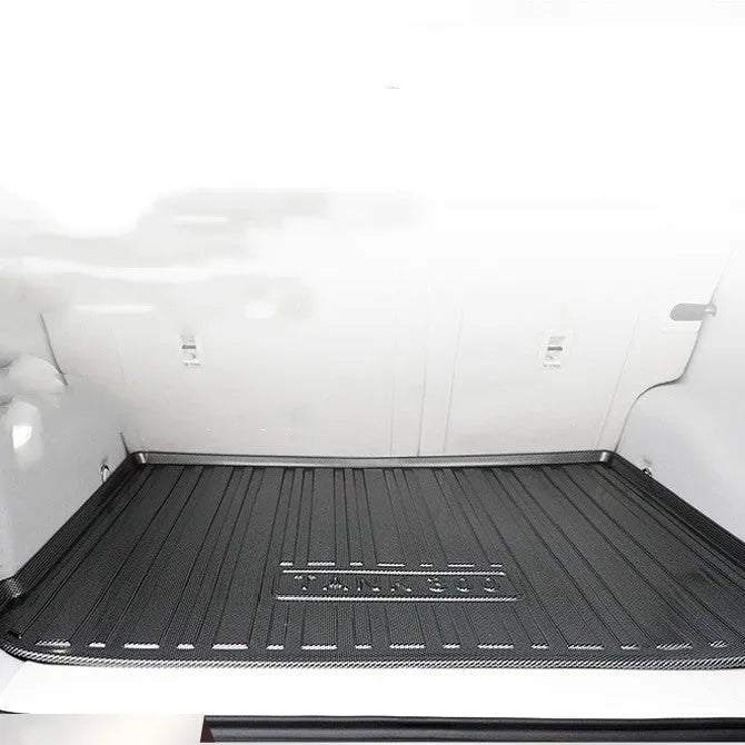 Black carbon fibre pattern TPE car boot liner mat for trunk protection.